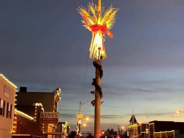 Street light decorated with wheat, lit up against the night skyline